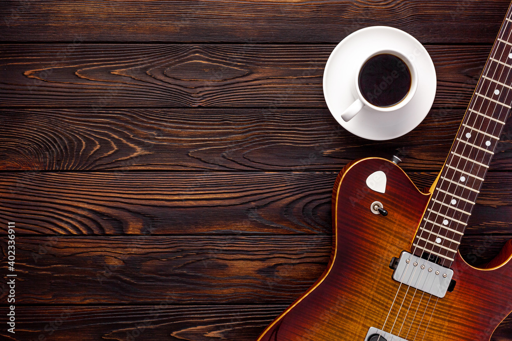 Beautiful electric guitar on with headphones and coffee desktop Photos |  Adobe Stock