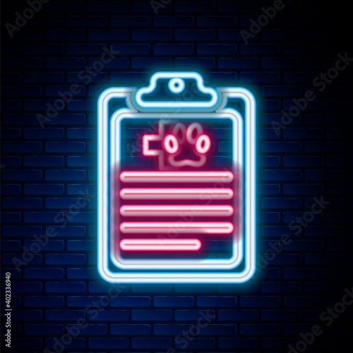 Glowing neon line Clipboard with medical clinical record pet icon isolated on brick wall background. Health insurance form. Medical check marks report. Colorful outline concept. Vector.