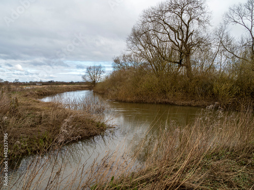 River Derwent at Wheldrake Ings in winter with a cloudy sky, North Yorkshire, England