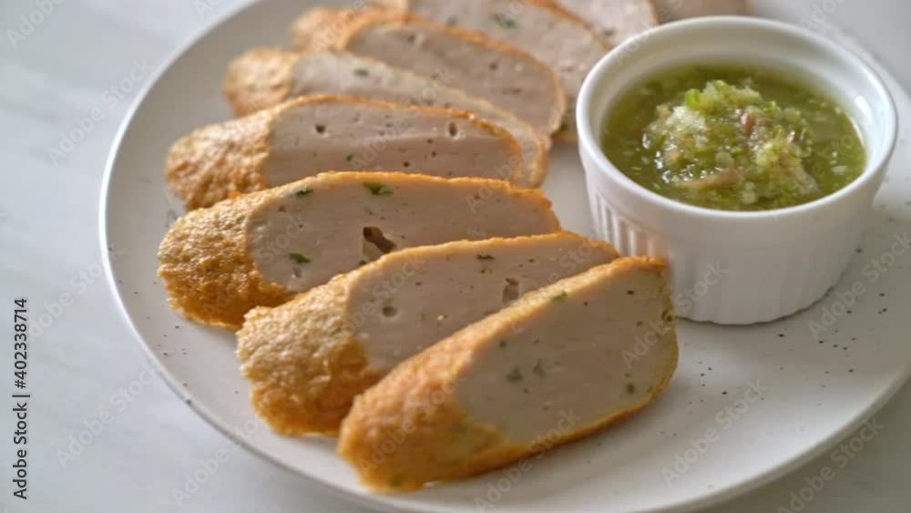 fried Chinese fish cake or fish ball line sliced with spicy seafood dipping sauce