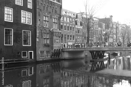 Canal with Bridge, Buildings and Bicycles, in Amsterdam Red Light District in Black and White