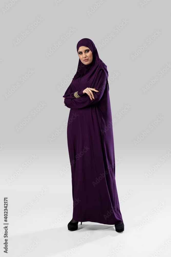 Purple. Beautiful arab woman posing in stylish hijab isolated on studio background with copyspace for ad. Fashion, beauty, style concept. Female model with trendy make up, manicure and accessories. Purple. Beautiful arab woman posing in stylish hijab isolated on studio background with copyspace for ad. Fashion, beauty, style concept. Female model with trendy make up, manicure and accessories.