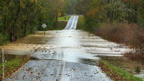 Country road flooded by tropical storm ETA photo