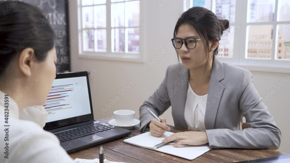 Serious female professional lawyer consult customer at business meeting in cafe. women give legal advice to lady client. elegant girl worker in suit explaining law with laptop computer in coffee shop Serious female professional lawyer consult customer at business meeting in cafe. women give legal advice to lady client. elegant girl worker in suit explaining law with laptop computer in coffee shop