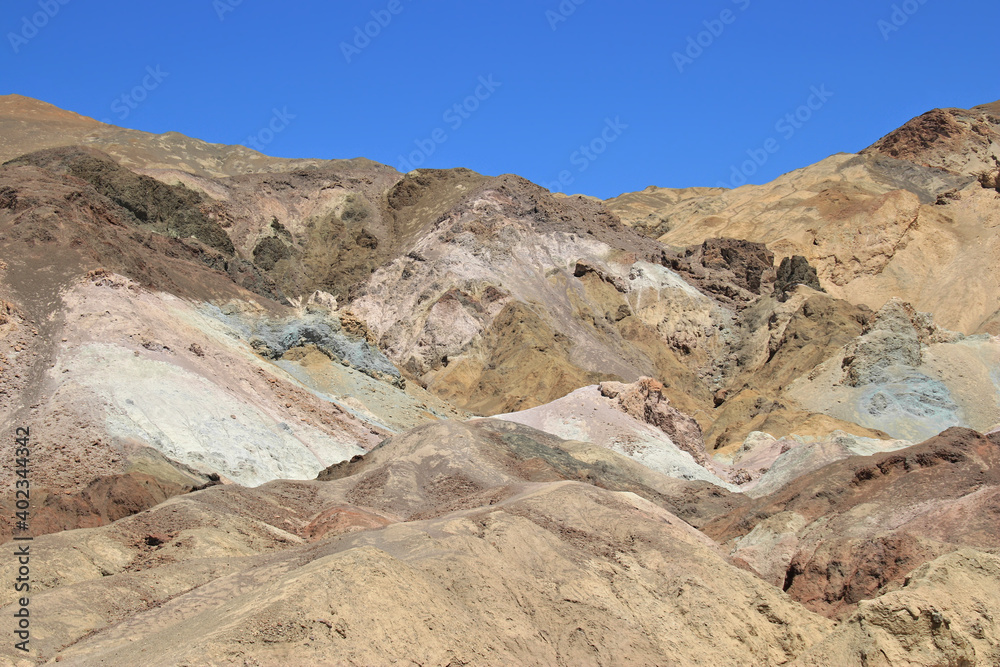 different stones in Death valley national park in front of a cloudless blue sk different stones in Death valley national park in front of a cloudless blue sk