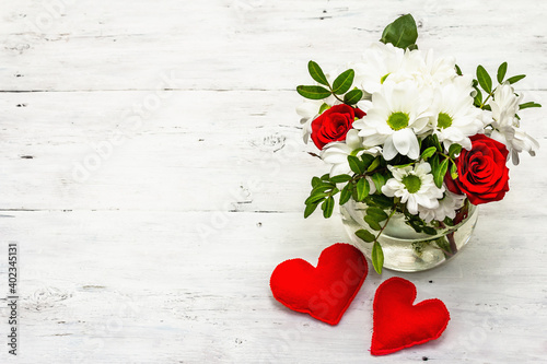 A bouquet of fresh flowers and red felt hearts for Valentine's day or Wedding