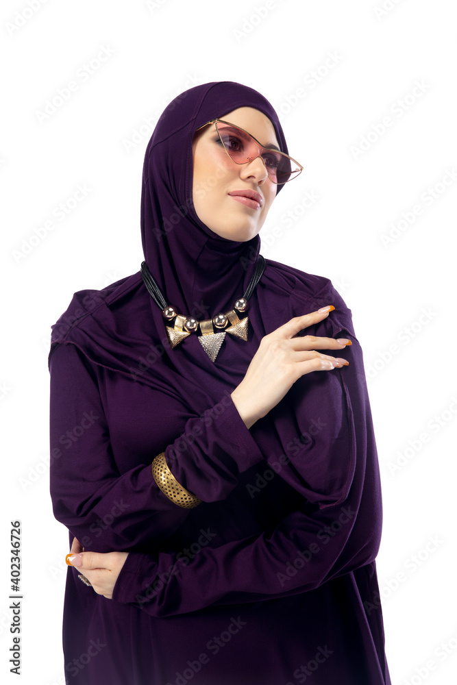 Dreamful. Beautiful arab woman posing in stylish hijab on studio background with copyspace for ad. Fashion, beauty, style concept. Female model with trendy make up, manicure and accessories.