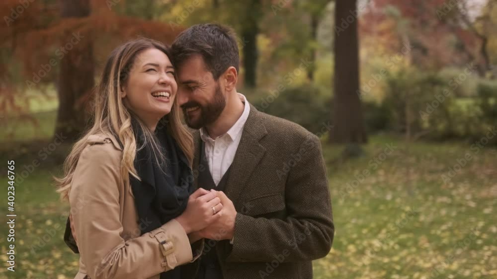 Handsome young couple walking in the autumn park Handsome young couple walking in the autumn park
