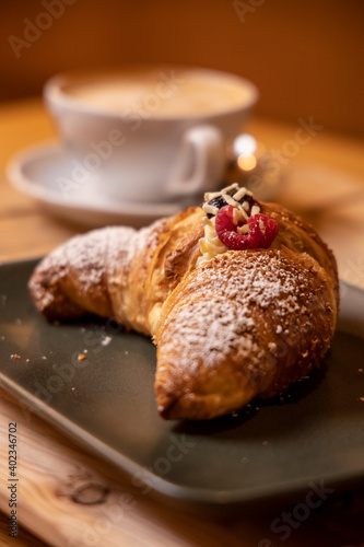 breakfast with chocolate raspberry and currant croissant and italian cappuccino