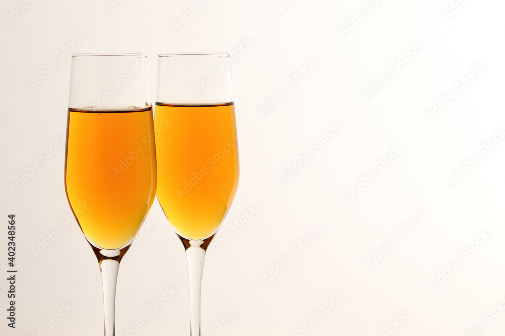 Two glasses of champagne, wine on a gray background. Alcoholic drink: champagne, beer, white wine. New year and Christmas background. Valentine's Day Two glasses of champagne, wine on a gray background. Alcoholic drink: champagne, beer, white wine. New year and Christmas background. Valentine's Day
