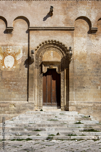 The western portal of the beautiful Matera Cathedral of Maria Santissima della Bruna, called the "door of the square" adorned with wonderful plant motif decorations. Matera, Basilicata, Italy, Europe. © Francesca