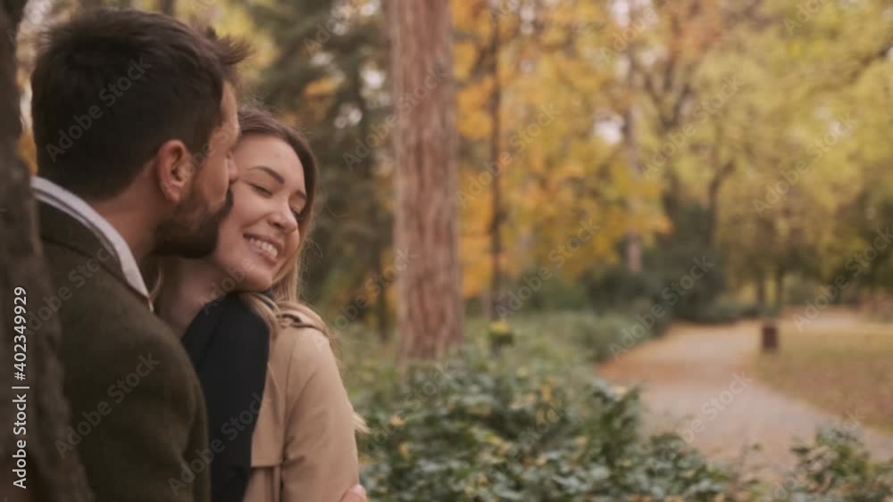 Handsome young couple walking in the autumn park Handsome young couple walking in the autumn park
