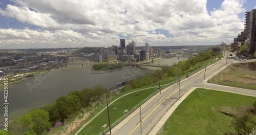 Establishing flying helicopter drone aerial of city buildings, three rivers, and car traffic on bridges of Pittsburgh, Pennsylvania skyscrapers, spring weather, and happy atmosphere photo