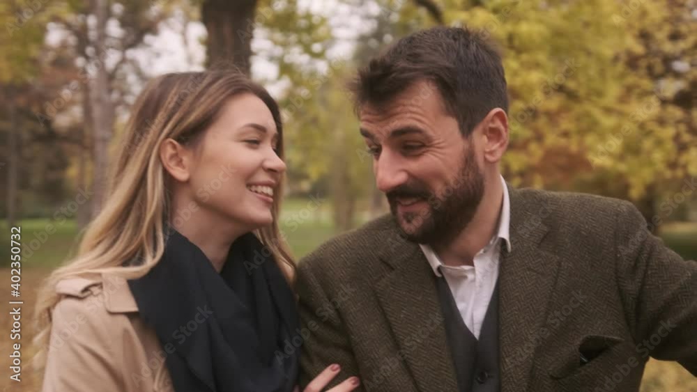 Handsome young couple walking in the autumn park Handsome young couple walking in the autumn park