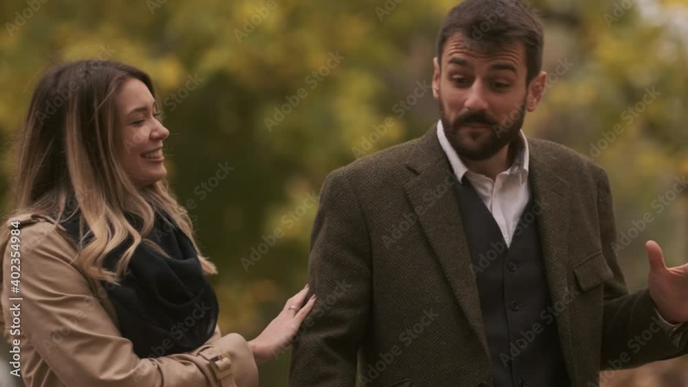 Handsome young couple walking in the autumn park Handsome young couple walking in the autumn park