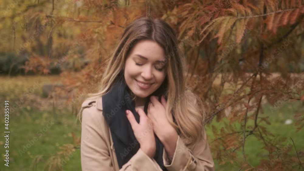 Beautiful young woman standing in the autumn park Beautiful young woman standing in the autumn park