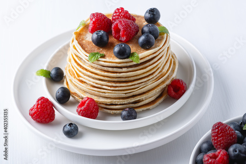 Traditional Russian pancakes with berries. Maslenitsa week. Pancake week..