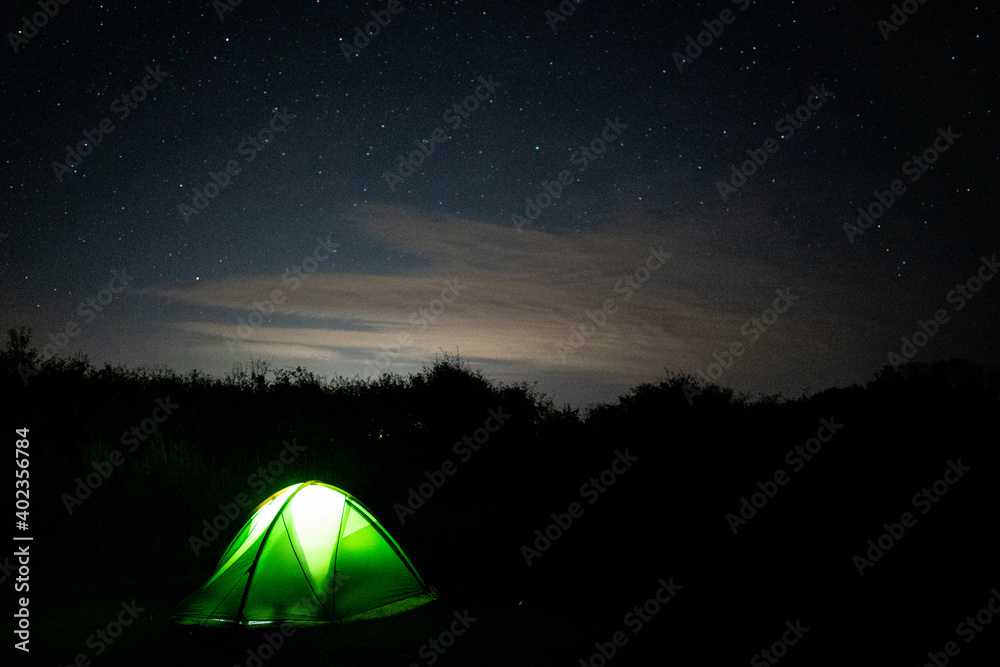 Stars in sky with enlighten camping tent - Astrophotography