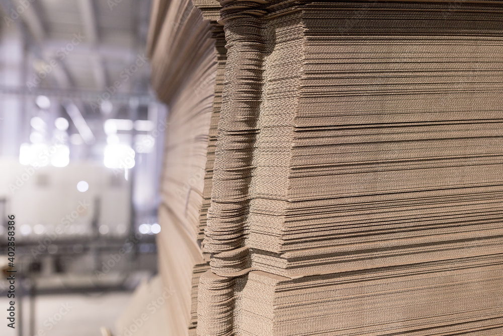 Perforated sheets of corrugated cardboard by stack on pallets after