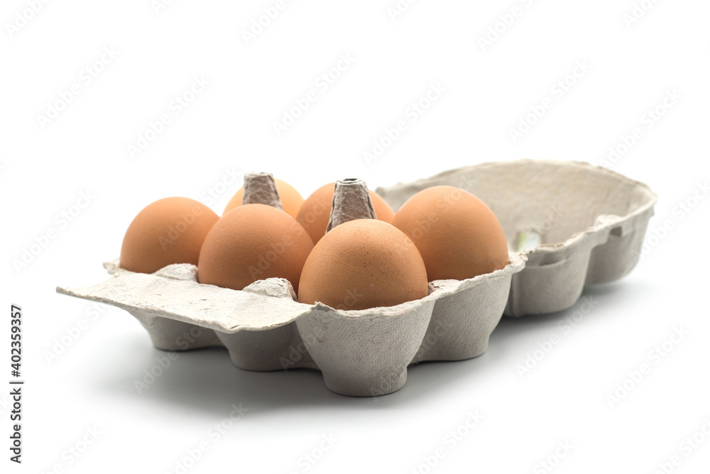 Closeup of organic eggs in a grey carton box on white background
