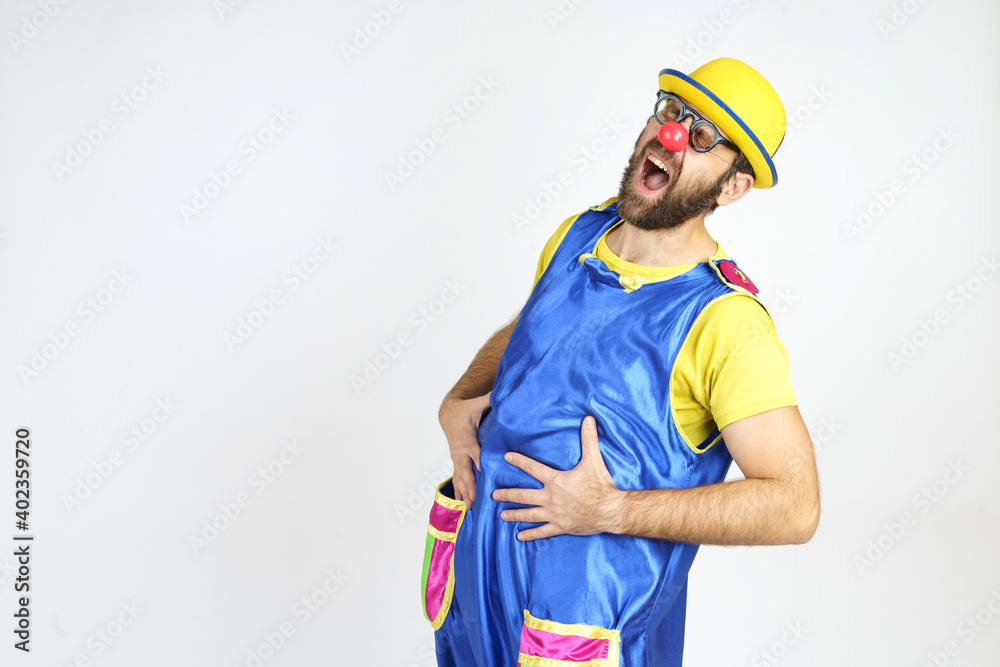The clown laughs, holds his stomach with his hands The clown laughs, holds his stomach with his hands