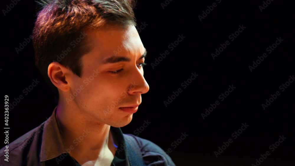 Attractive young guy dancing in the club. Cool stylish man relaxes in neon disco lights Attractive young guy dancing in the club. Cool stylish man relaxes in neon disco lights