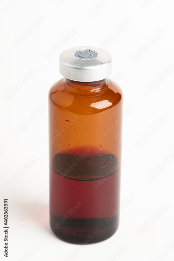 Macro Image Of Amber Vaccine Vial In White Background Macro Image Of Amber Vaccine Vial In White Background