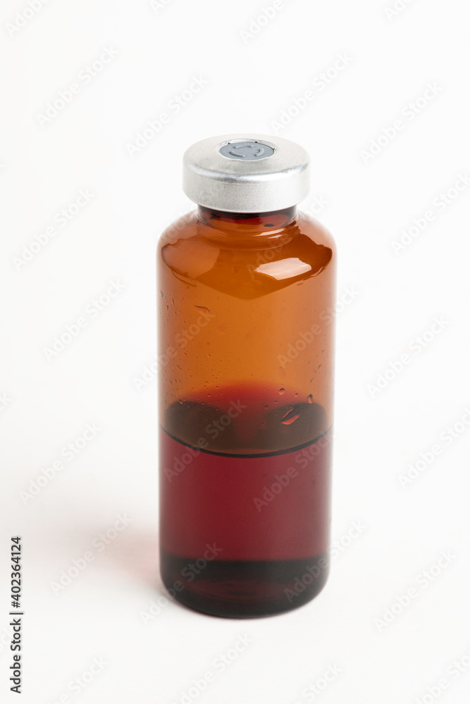 Macro Image Of Amber Vaccine Vial In White Background Macro Image Of Amber Vaccine Vial In White Background