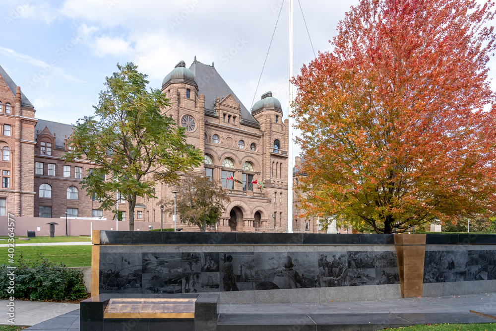 Fototapeta premium Toronto, Canada - October 24, 2019: Ontario Veterans' War Memorial with the Ontario Legislative Building in background in Toronto. The Memorial is dedicated to Canadian military service members.