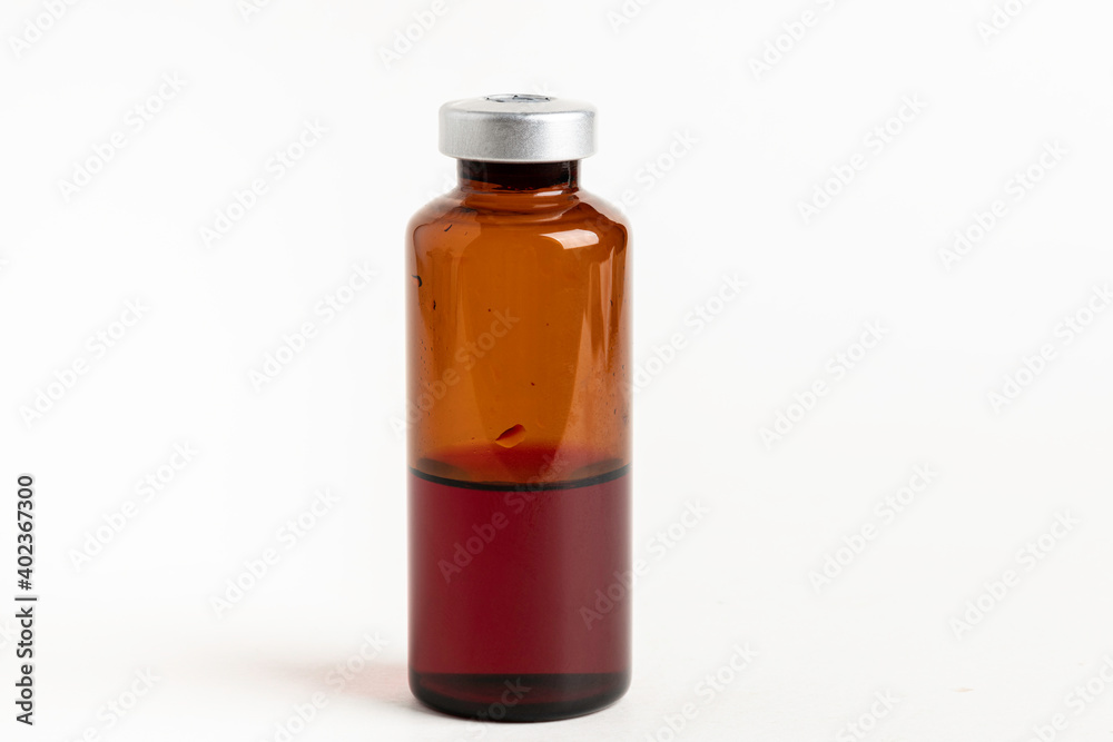 Macro Image Of Amber Vaccine Vial In White Background