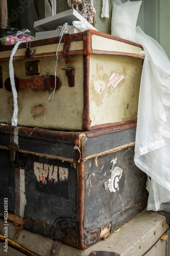 Vintage suitcases stacked with fabric draped over them