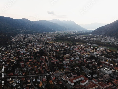 Aerial view of alpine swiss city Bellinzona and Giubiasco with Lago Maggiore lake in background Ticino Switzerland photo