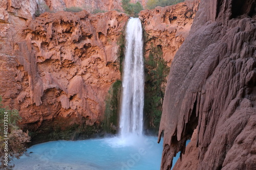 Havasupai waterfall into blue pool and red canyons