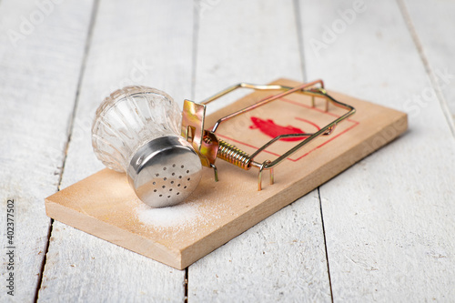 Mouse trap and bait salt. Too much salt is unhealthy. photo