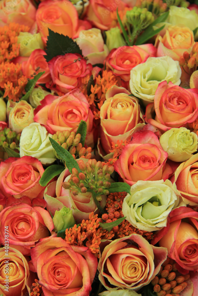 Orange and yellow roses in a bridal bouquet Orange and yellow roses in a bridal bouquet