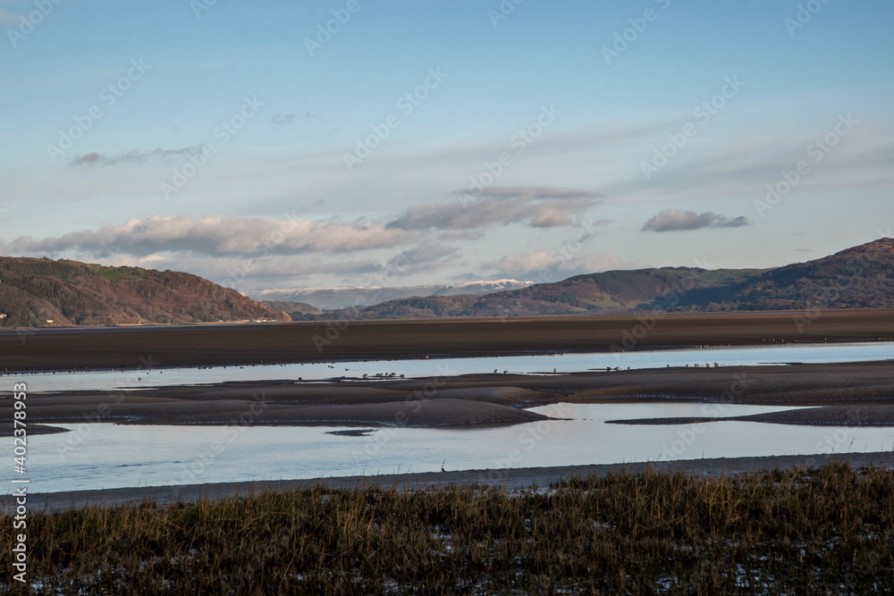 a view at Ynyslas beach of the estuary of the river Dyfi with the Leri feeding into the end of the river 