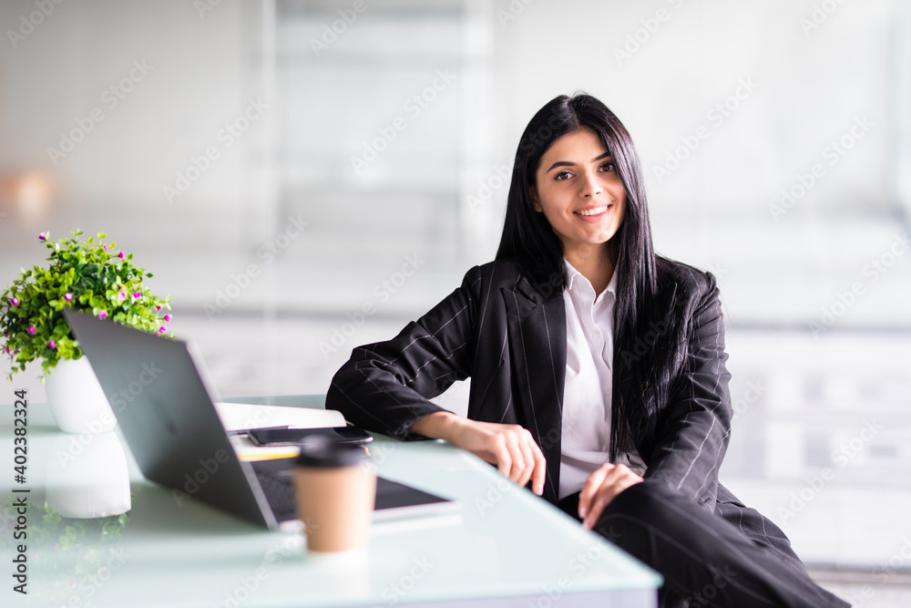 Young pretty business woman with laptop in the office Young pretty business woman with laptop in the office