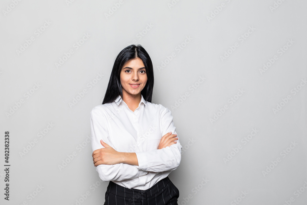 Smiling business woman with folded hands against white background. Smiling business woman with folded hands against white background.