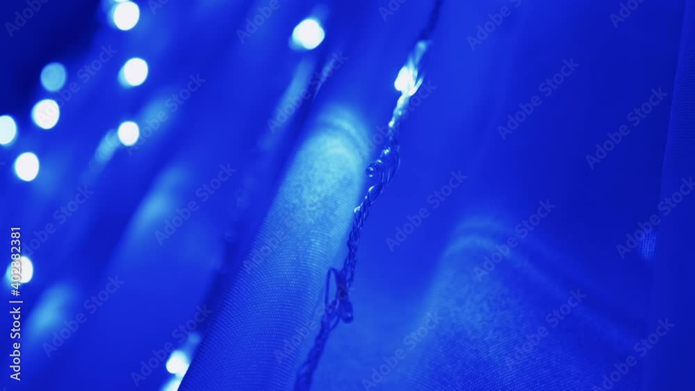 Christmas Garland of Many Blinking, Flickering Blue LED Lights on Curtain. Zoom Christmas Garland of Many Blinking, Flickering Blue LED Lights on Curtain. Zoom