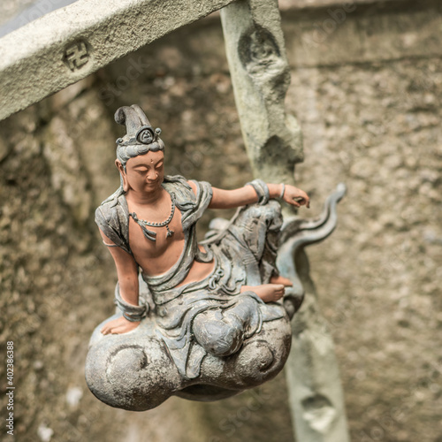 stone statue of bodhisattva sit on a cloud