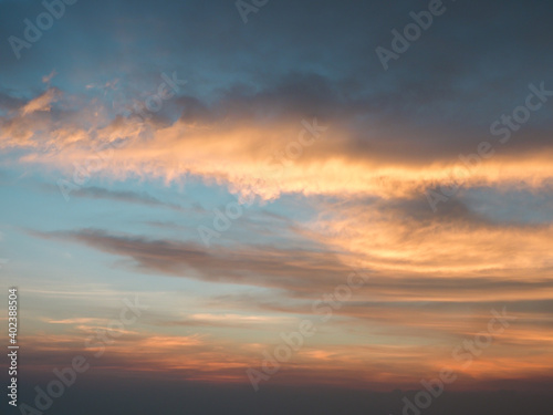 Fototapeta Naklejka Na Ścianę i Meble -  Beautiful orange sunset sky with large white clouds.