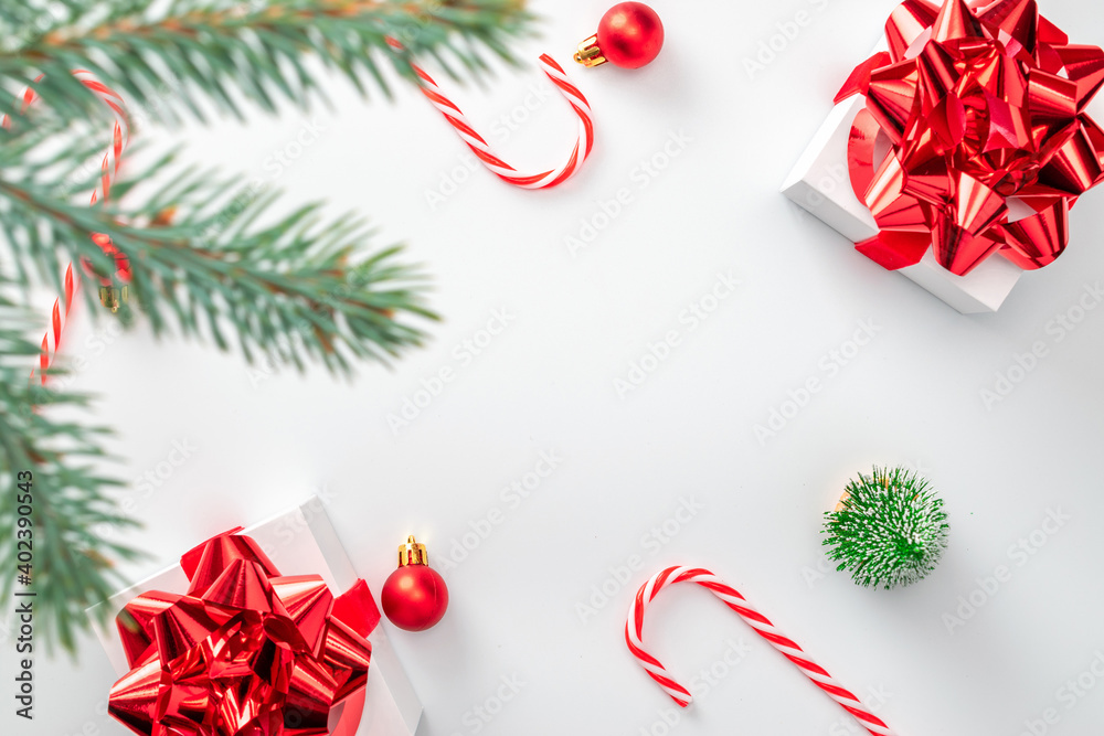 Happy new year. White gifts with scarlet bow, red balls and sparkling lights in xmas decoration on white background for greeting card. Christmas, winter, new year concept. Happy new year. White gifts with scarlet bow, red balls and sparkling lights in xmas decoration on white background for greeting card. Christmas, winter, new year concept.