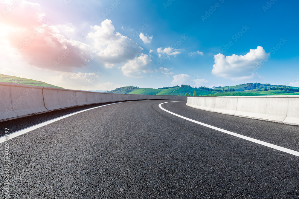 Fototapeta premium Asphalt road and mountain with tea plantation at sunset.Road and mountain background.