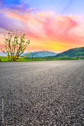 Asphalt road and mountain with tea plantation at sunset.Road and mountain background.