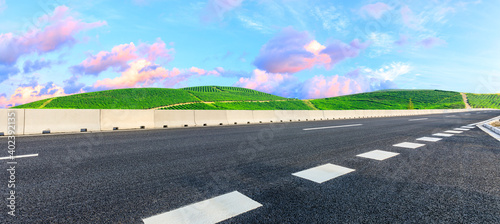 Asphalt road and mountain with tea plantation at sunset.Road and mountain background.