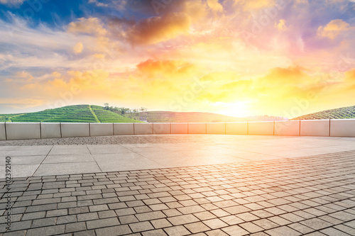 Empty square floor and green mountain background.