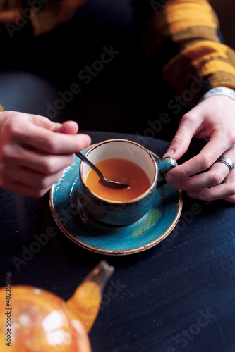 person holding a cup of tea