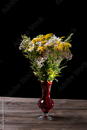 Wildflowers in a red glass vase