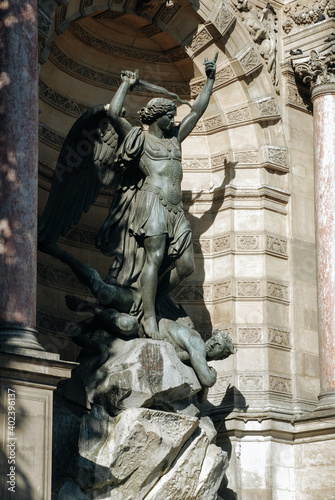 Fountain of St. Michael with sculptures of the archangel and the defeated serpent. Paris, France. photo