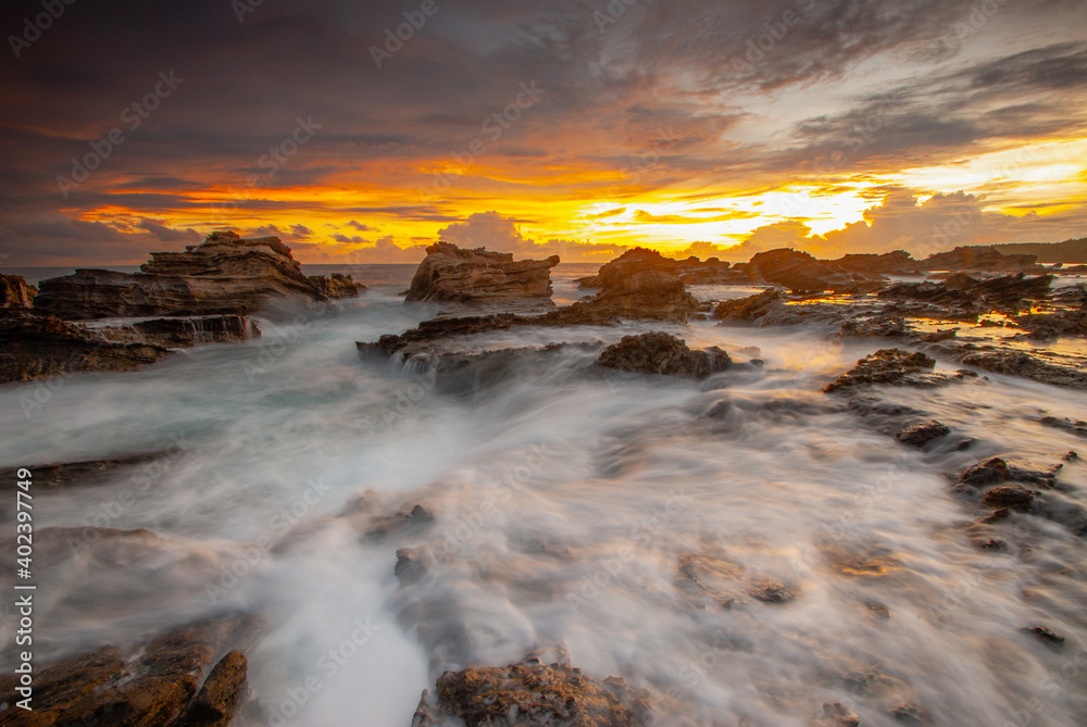 Beach sunset with rock foreground at Sawarna Beach no people Beach sunset with rock foreground at Sawarna Beach no people
